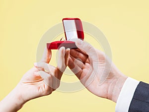 Man presents golden ring for young woman