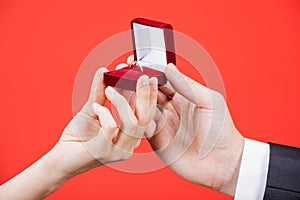 Man presents golden ring for young woman