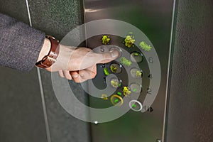 Man press button in elevator with germs, closeup