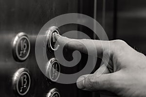 The man presses the elevator button.