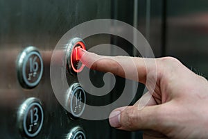 The man presses the elevator button