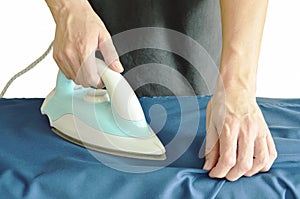Man pressing automatic electric iron to shirt on ironing board