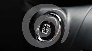 Man is pressing the button engine start in car. Start car engine by pushing a button. Close-up.