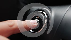 Man is pressing the button engine start in car. Start car engine by pushing a button. Close-up.