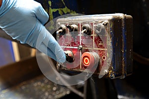 Man pressing button on an industrial machine