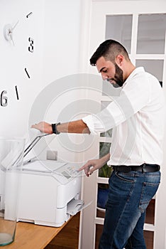 Man pressing buttons on a photo copier
