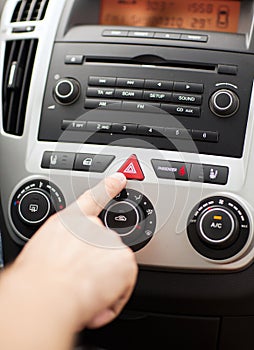 Man pressing car hazard warning button