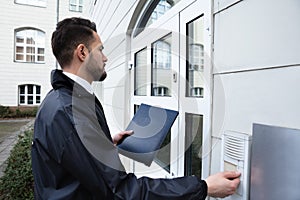 Man Pressing The Door Bell