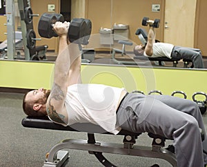 Man Pressing Fifty Pound Dumbbells