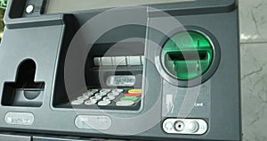 Man pressing keypad of an ATM machine