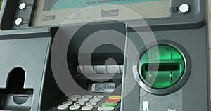 Man pressing keypad of an ATM machine