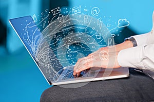 Man pressing notebook laptop computer with doodle icon cloud symbols