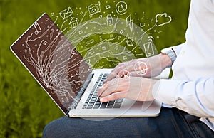 Man pressing notebook laptop computer with doodle icon cloud symbols