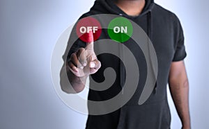 Man pressing on or off button