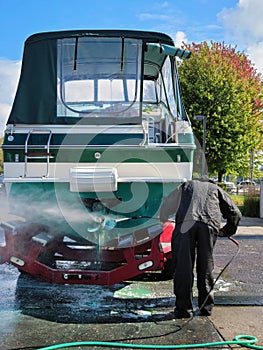 Man Pressure Washing Powerboat