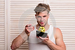 Man pretends to eat noodles on light wooden background