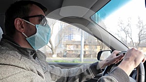 Man Prevent Coronavirus.A man driving in a medical mask