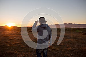 Man in a pristine landscape during a beautiful blazing sunset