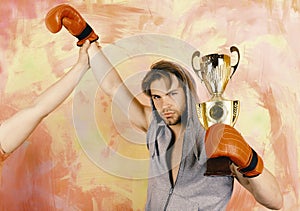 Man with prize on colorful background. Boxer with serious face
