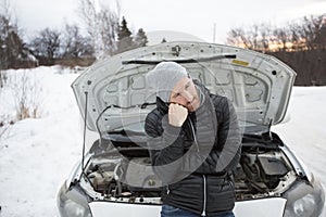 Man problem close to the broken car in winter