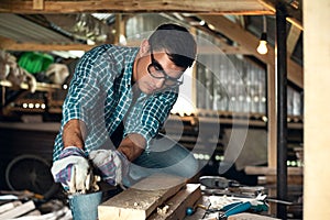 Man in the process of wood processing manual planing machine in the home workshop, manual labor, home craftsman