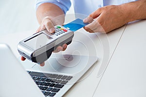 The man processing credit card transaction with pos terminal