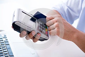 The man processing credit card transaction with pos terminal