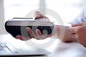 The man processing credit card transaction with pos terminal