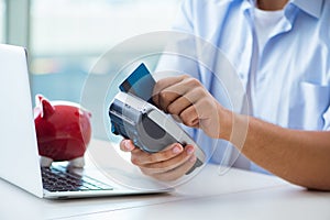 The man processing credit card transaction with pos terminal