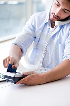 The man processing credit card transaction with pos terminal