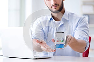 The man processing credit card transaction with pos terminal