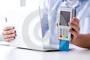 The man processing credit card transaction with pos terminal