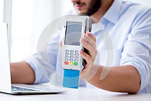 The man processing credit card transaction with pos terminal