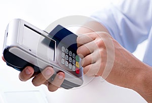 Man processing credit card transaction with POS terminal