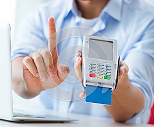 Man processing credit card transaction with POS terminal