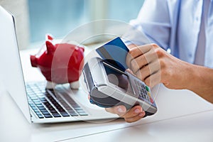 The man processing credit card transaction with pos terminal