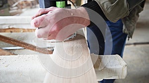 Man processing wood with router in a workshop