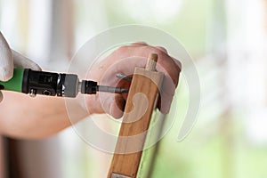 Man processing wood with tool against blurred background