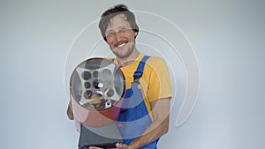 A man professional home renovator holds a Propane Hot Air Heater in his arms. He looks at the camera smiling