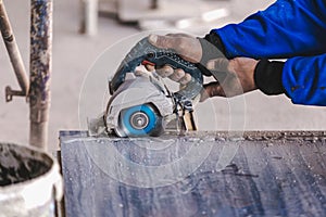 Man professional worker cutting tile