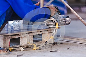 Man professional worker cutting tile