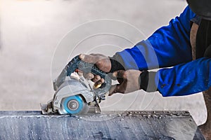 Man professional worker cutting tile