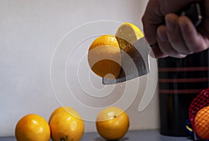 A man professionally cuts a orange photo