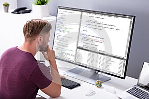 Man Programming Code On Computer