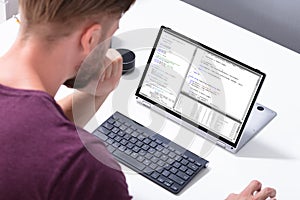 Man Programming Code On Laptop Computer