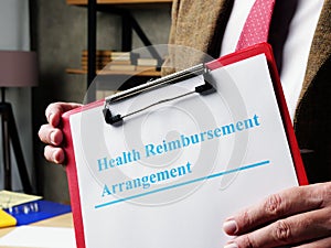 Man proposes Health Reimbursement Arrangement HRA papers.