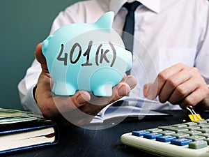 Man proposes piggy bank with sign 401k. Retirement pension plan