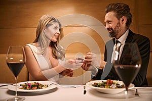 Man proposes to his companion over romantic dinner in restaurant