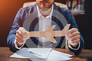 Man proposing a life insurance policy, the agent is holding the wooden plane