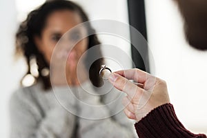 Man proposing to his girlfriend with diamond ring